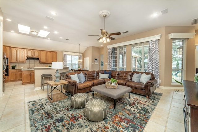 living area with light tile patterned floors, visible vents, and recessed lighting