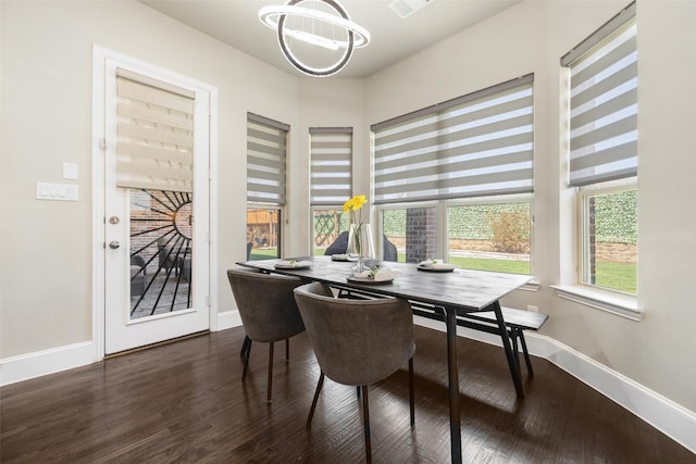 dining space featuring baseboards and wood finished floors