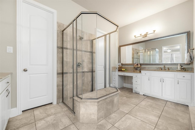 full bathroom featuring tile patterned flooring, a shower stall, and vanity