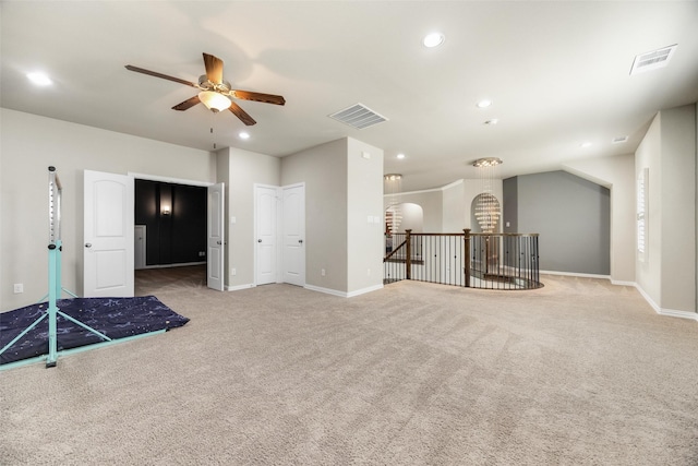 carpeted empty room featuring baseboards, visible vents, and recessed lighting