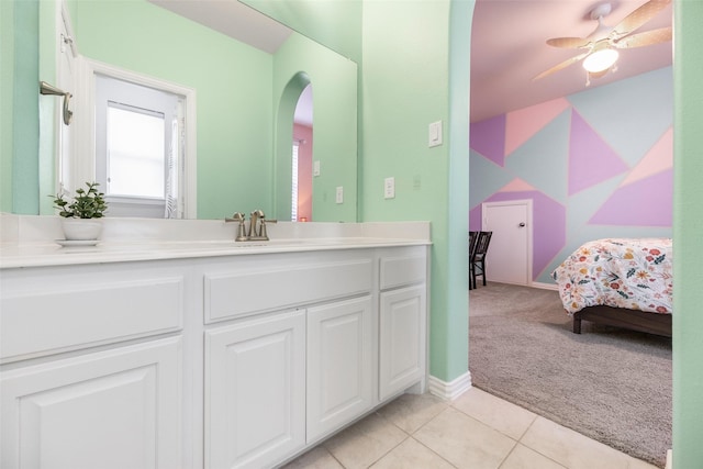 bathroom with ensuite bathroom, ceiling fan, vanity, and tile patterned floors