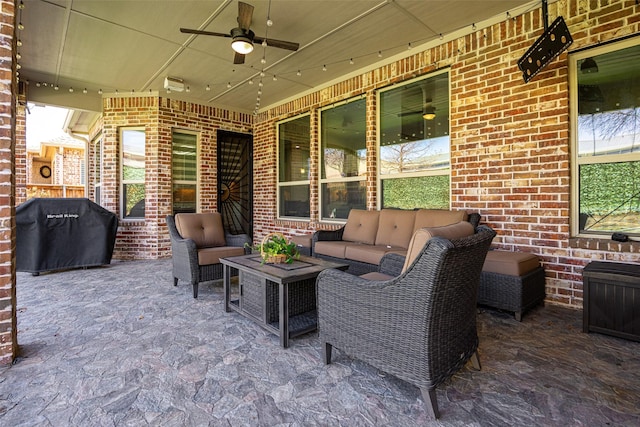 view of patio / terrace featuring grilling area, an outdoor living space, and a ceiling fan