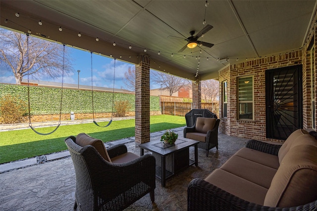 view of patio featuring a ceiling fan, a fenced backyard, and an outdoor hangout area