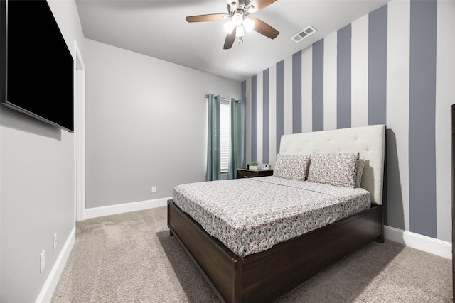 bedroom with light colored carpet, visible vents, baseboards, and wallpapered walls