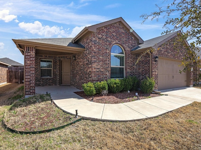 ranch-style home with brick siding, fence, and an attached garage