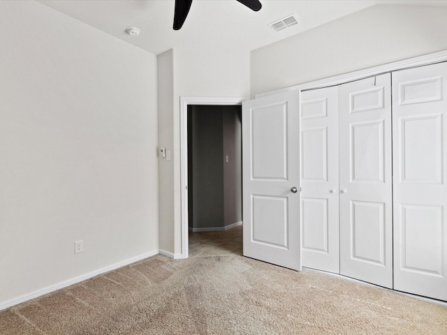 unfurnished bedroom featuring carpet flooring, a ceiling fan, visible vents, baseboards, and a closet