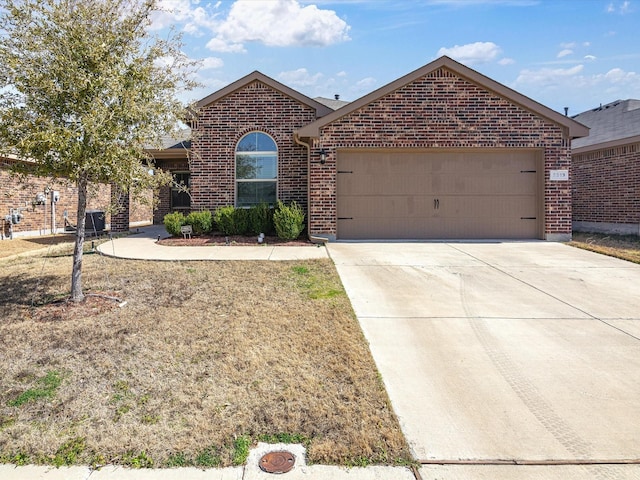 ranch-style house with concrete driveway, brick siding, and an attached garage