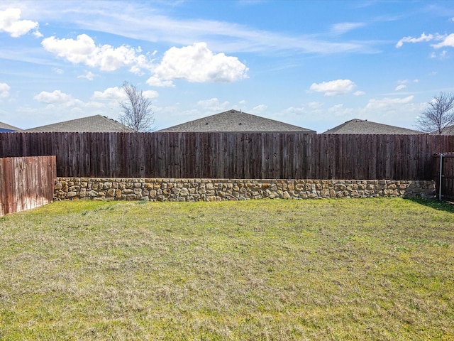 view of yard with a fenced backyard