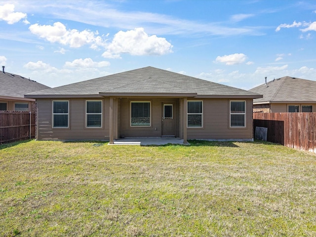 rear view of house featuring a patio area, a fenced backyard, and a lawn