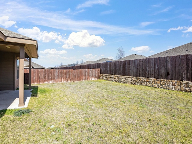 view of yard with a fenced backyard and a patio