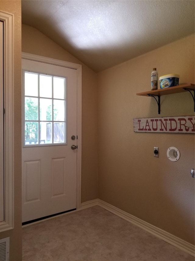 entryway featuring lofted ceiling, visible vents, and baseboards