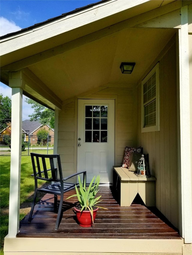 wooden deck with covered porch, a yard, and fence