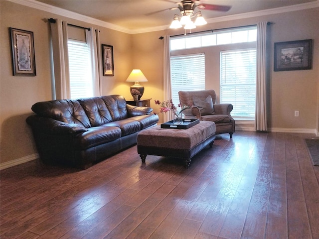 living room featuring dark wood-style floors, crown molding, baseboards, and ceiling fan