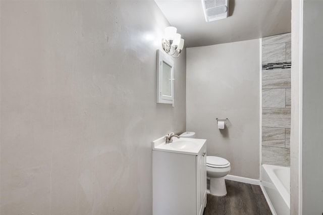 full bathroom with visible vents, toilet, a bathing tub, wood finished floors, and vanity