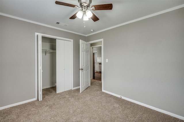 unfurnished bedroom with baseboards, visible vents, crown molding, and light colored carpet