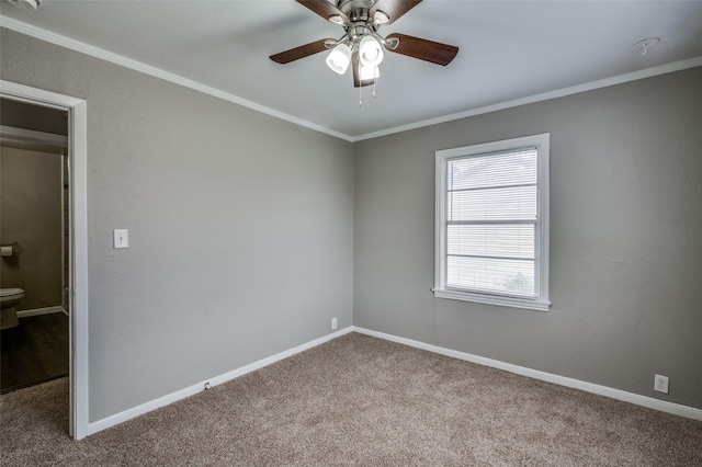 empty room featuring carpet, ornamental molding, and baseboards