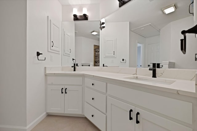 full bath with double vanity, curtained shower, a sink, and baseboards