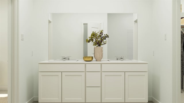 bathroom featuring a sink, baseboards, and double vanity