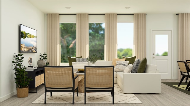 sitting room with light wood-type flooring and baseboards