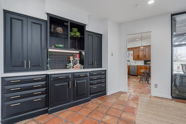 bar featuring light tile patterned floors, tasteful backsplash, baseboards, stainless steel dishwasher, and recessed lighting