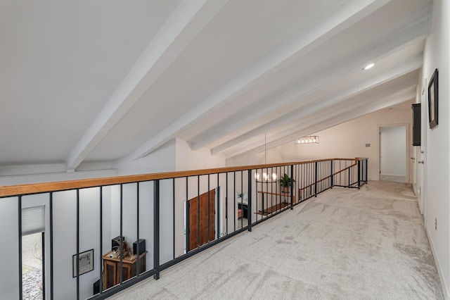 hallway with lofted ceiling with beams and carpet