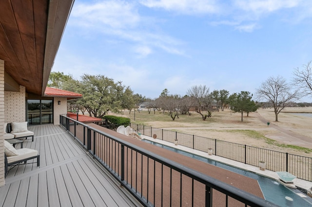 wooden deck with a fenced in pool and fence