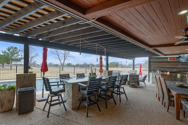 view of patio / terrace featuring outdoor dry bar, fence, and outdoor dining area