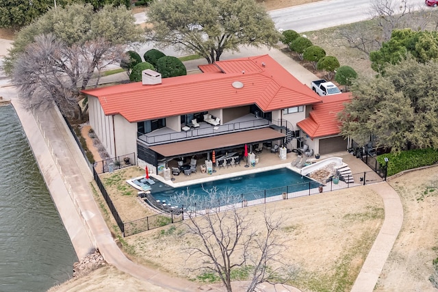 exterior space with a patio, a fenced backyard, a balcony, a fenced in pool, and stucco siding