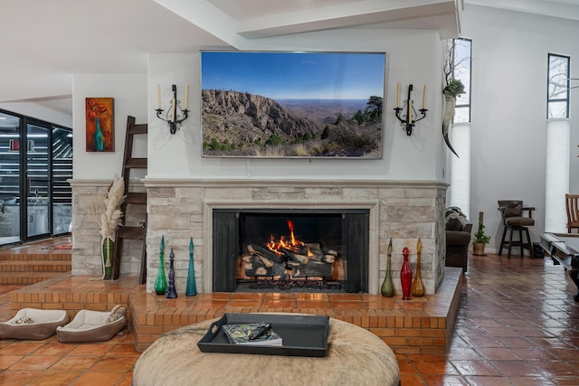 tiled living area featuring a warm lit fireplace and beamed ceiling