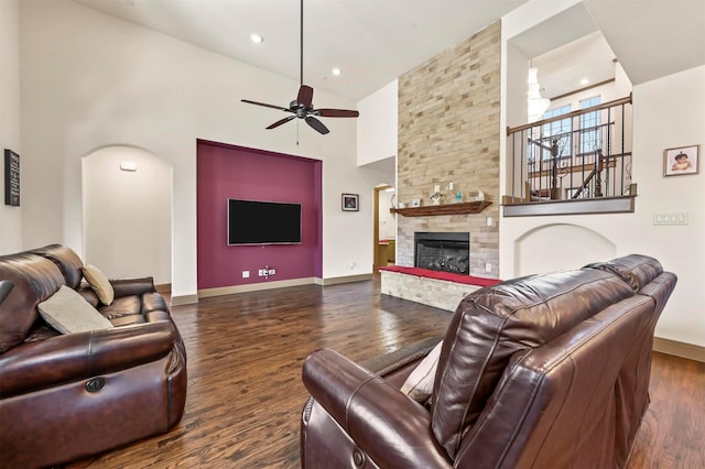 living room featuring high vaulted ceiling, baseboards, a ceiling fan, and dark wood-style floors