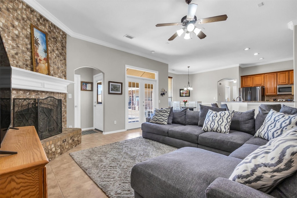 1527 Meadowbrook Ln, Nevada, TX 75173 - living room with arched walkways, ceiling fan, crown molding, and light tile patterned flooring