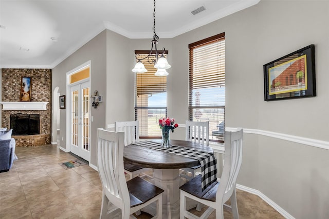 dining space featuring a healthy amount of sunlight, visible vents, ornamental molding, and french doors