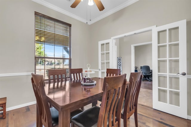 dining space featuring french doors, crown molding, baseboards, and wood finished floors