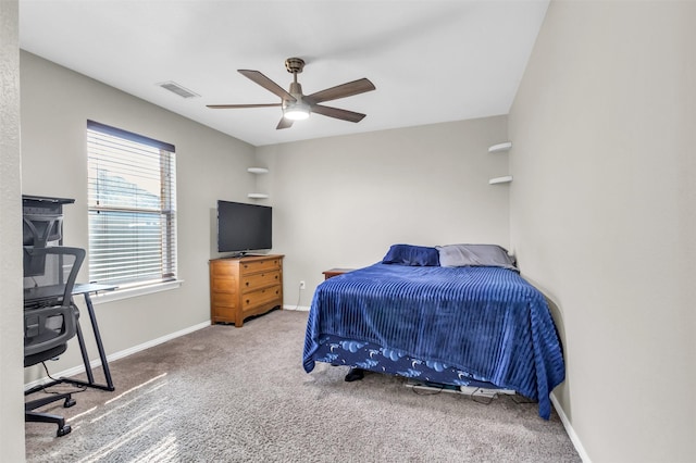 carpeted bedroom featuring ceiling fan, visible vents, and baseboards