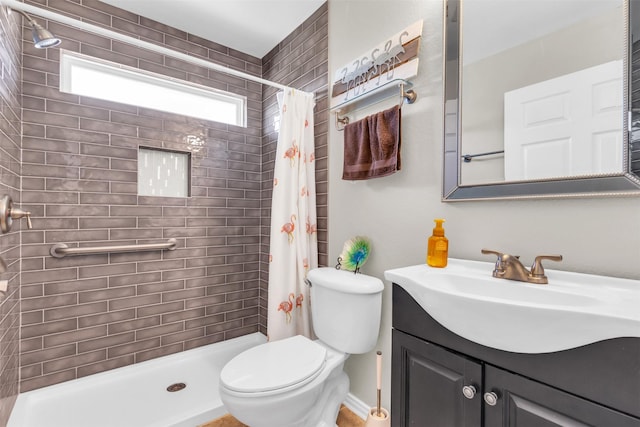 full bath featuring toilet, tiled shower, and vanity