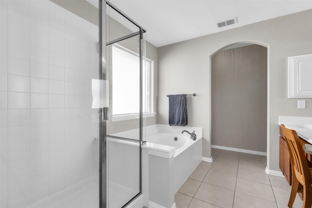 full bathroom featuring visible vents, a shower stall, vanity, a bath, and tile patterned floors