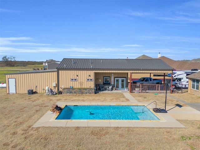 view of swimming pool featuring a patio, french doors, fence, and a fenced in pool