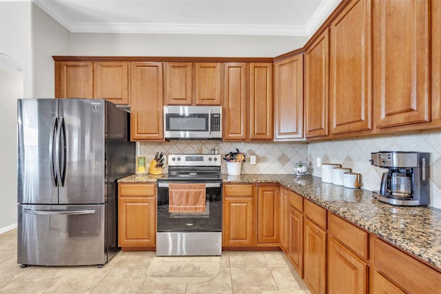 kitchen featuring stainless steel appliances, stone countertops, and brown cabinets