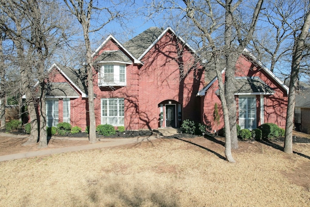 traditional-style home with brick siding