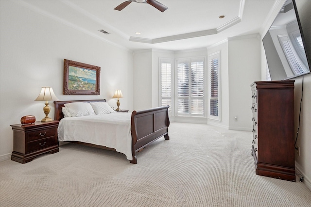 bedroom featuring light carpet, visible vents, baseboards, ornamental molding, and a raised ceiling