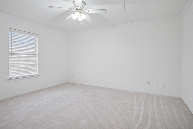 unfurnished room with baseboards, ornamental molding, a ceiling fan, and light colored carpet