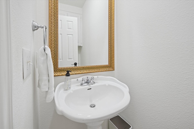 bathroom with a sink and a textured wall