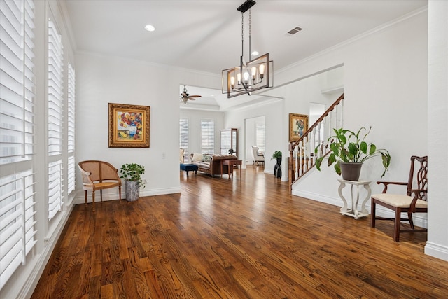 interior space with stairs, baseboards, crown molding, and wood finished floors