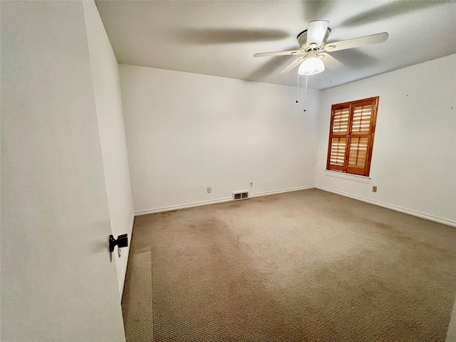 unfurnished room featuring carpet, visible vents, ceiling fan, and baseboards