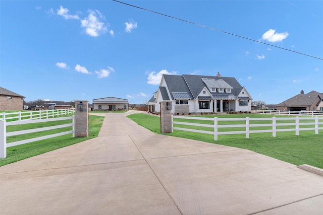 view of front of house featuring a standing seam roof, a fenced front yard, metal roof, and a front yard