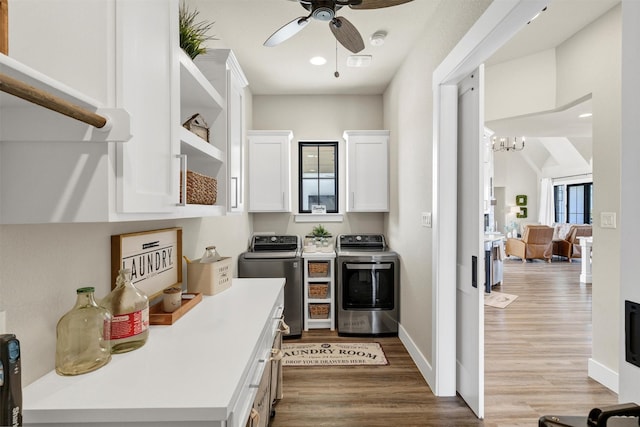 kitchen featuring white cabinetry, open shelves, light countertops, and washing machine and clothes dryer