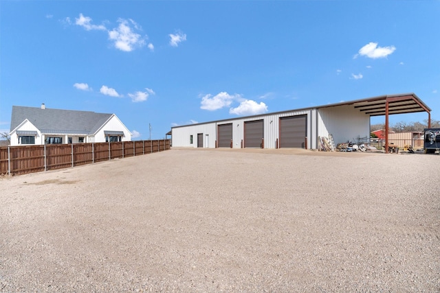 view of outbuilding with fence and an outdoor structure