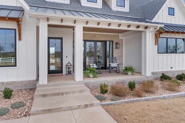 doorway to property featuring covered porch, a shingled roof, board and batten siding, and a standing seam roof