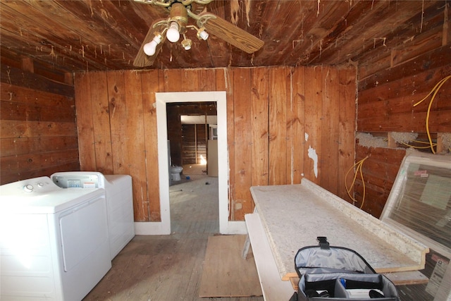 laundry room featuring ceiling fan, wooden walls, wood finished floors, wood ceiling, and independent washer and dryer