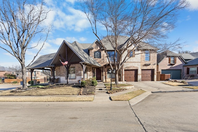 view of front of house featuring driveway, a garage, a residential view, and brick siding